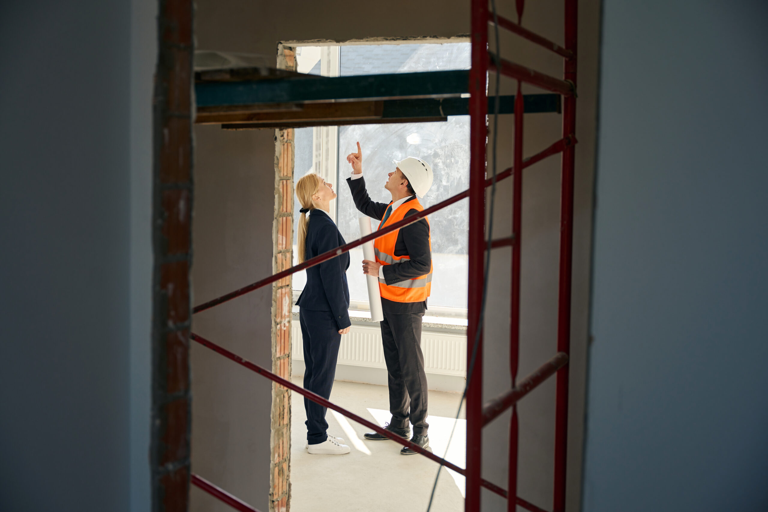 Architect and client standing in unfinished room